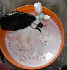 How to dip tie dye t-shirts into a soda ash water solution.